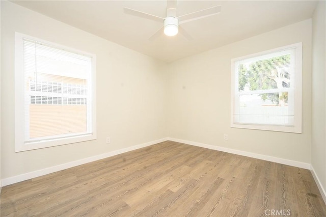 spare room with ceiling fan, baseboards, and wood finished floors