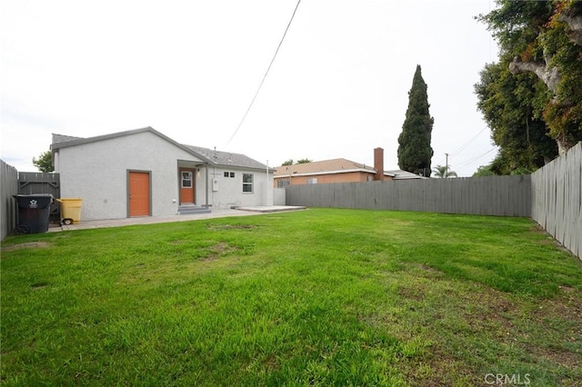 view of yard with a fenced backyard and a patio area