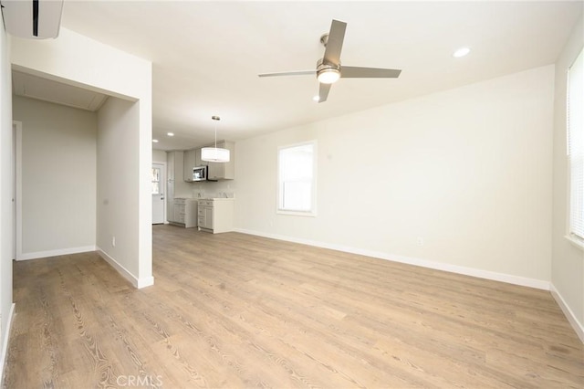 unfurnished living room featuring light wood-type flooring, ceiling fan, baseboards, and recessed lighting