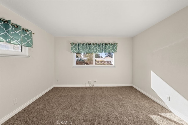 carpeted spare room with plenty of natural light