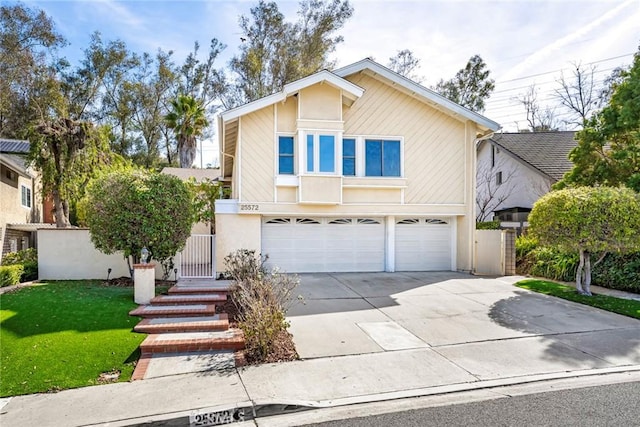 view of property with a front yard and a garage