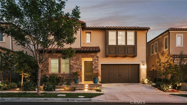 mediterranean / spanish-style house with a garage