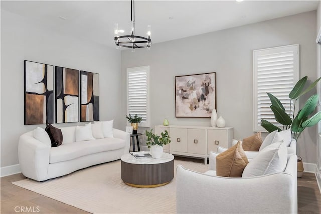 living room featuring light hardwood / wood-style floors, a chandelier, and plenty of natural light