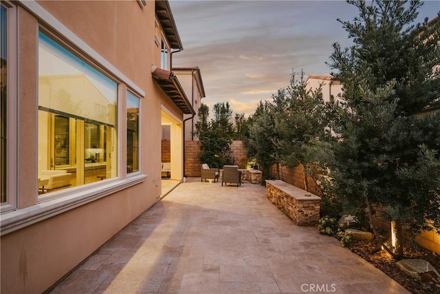 view of patio terrace at dusk