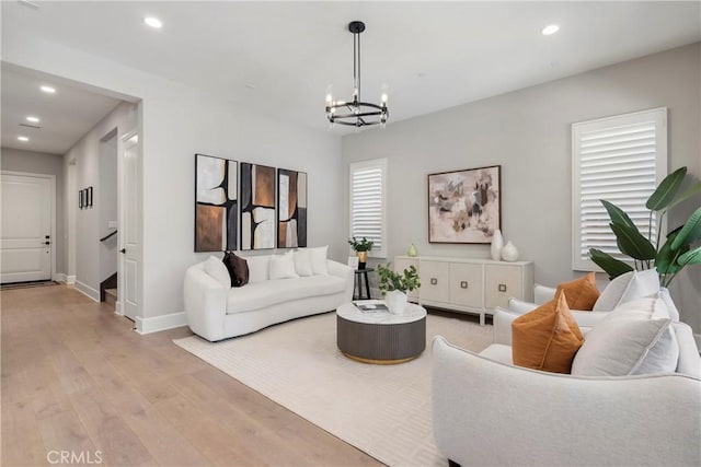 living room featuring light hardwood / wood-style flooring and a chandelier