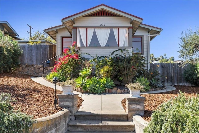 view of front of house featuring fence