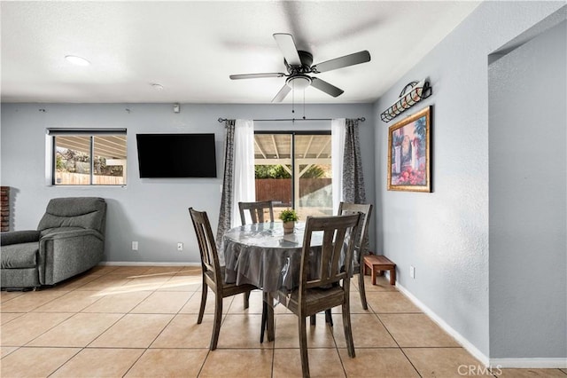 dining area featuring light tile patterned flooring, a wealth of natural light, and ceiling fan