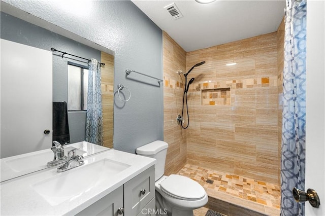 bathroom with vanity, toilet, and walk in shower