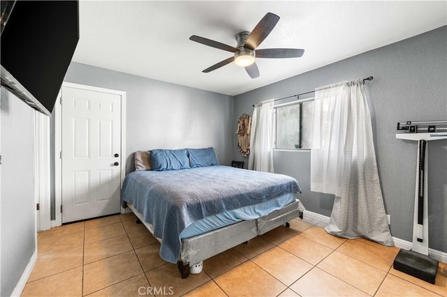 tiled bedroom featuring ceiling fan