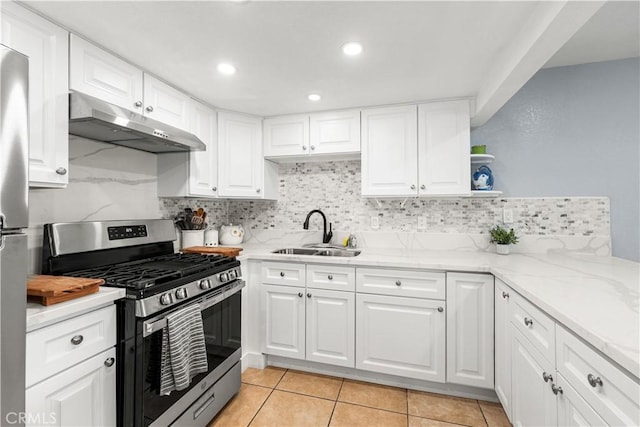 kitchen featuring light stone countertops, sink, appliances with stainless steel finishes, white cabinets, and decorative backsplash