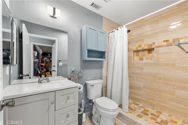 bathroom featuring toilet, vanity, and a shower with shower curtain