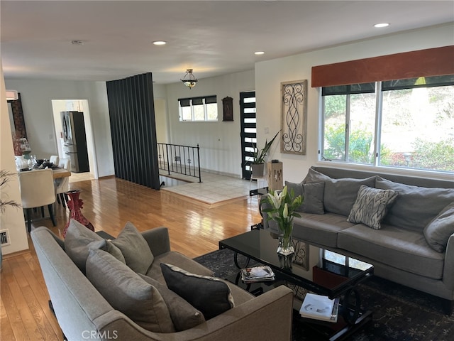 living room featuring a wealth of natural light, light wood-style flooring, and recessed lighting