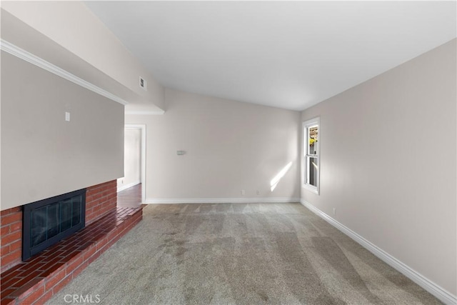 unfurnished living room featuring carpet flooring, a fireplace, visible vents, and baseboards