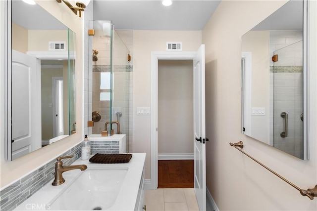 full bath featuring tile patterned flooring, a shower stall, visible vents, and baseboards