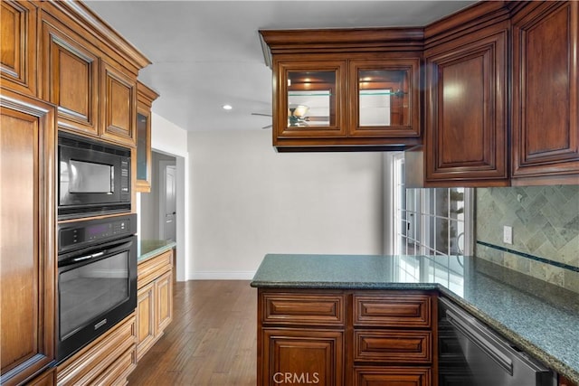 kitchen featuring decorative backsplash, dark wood-style floors, glass insert cabinets, a peninsula, and black appliances