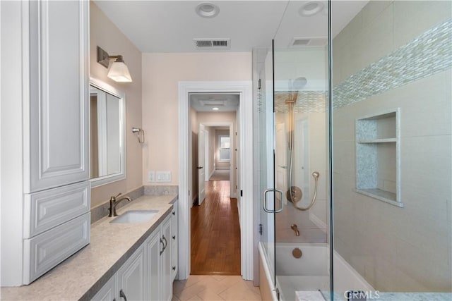 full bath featuring tile patterned flooring, visible vents, vanity, and an enclosed shower