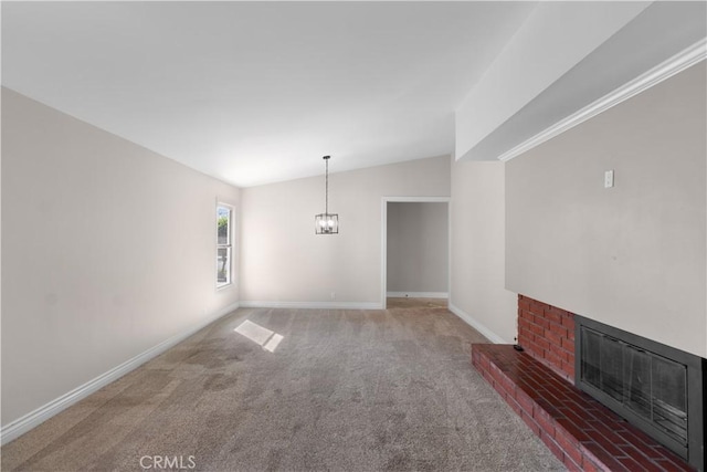 unfurnished dining area with carpet floors, vaulted ceiling, a fireplace, and baseboards