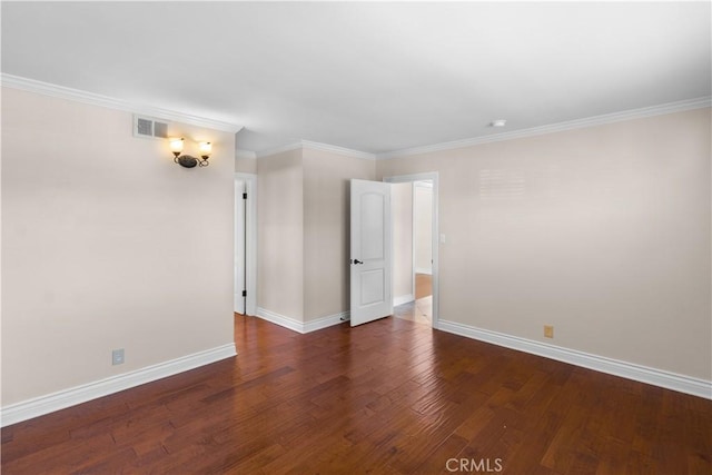 unfurnished room with ornamental molding, wood finished floors, visible vents, and baseboards