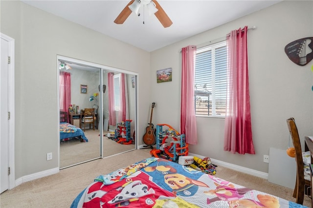 bedroom featuring ceiling fan, light carpet, and a closet