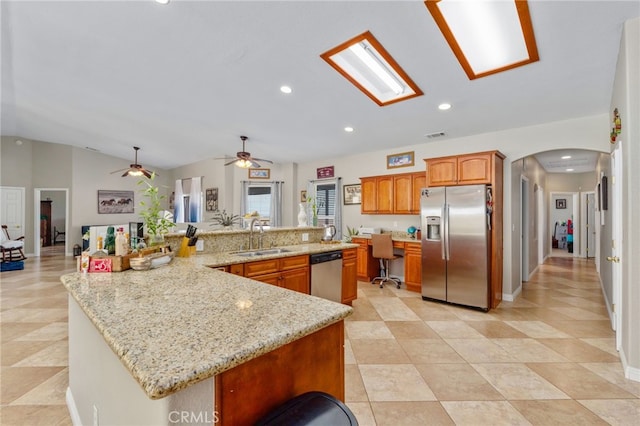 kitchen featuring sink, stainless steel appliances, a large island, and lofted ceiling