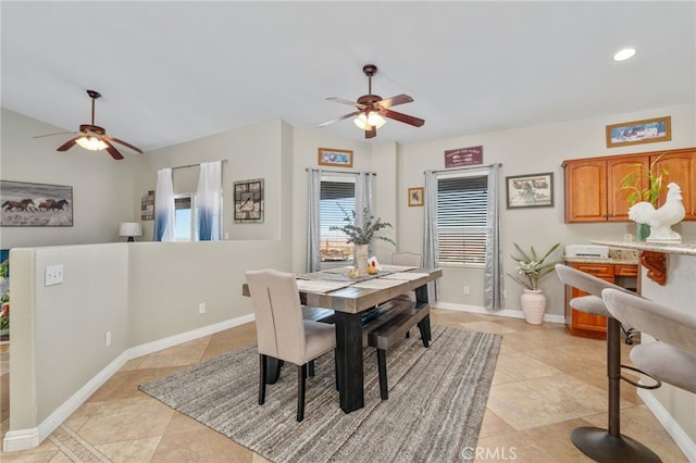 tiled dining room with vaulted ceiling and ceiling fan