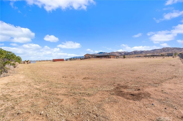 view of yard featuring a mountain view and a rural view