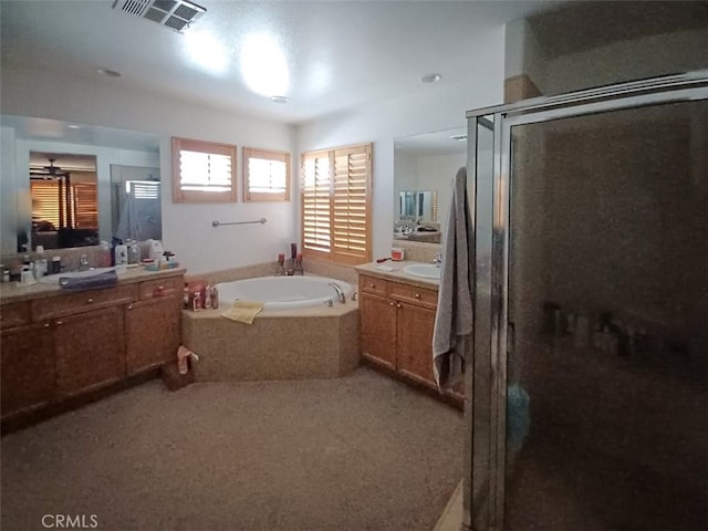 bathroom featuring shower with separate bathtub and vanity