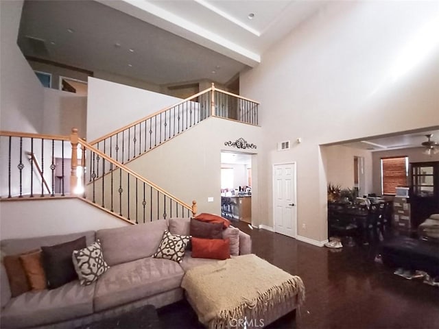 living room with a high ceiling and hardwood / wood-style floors