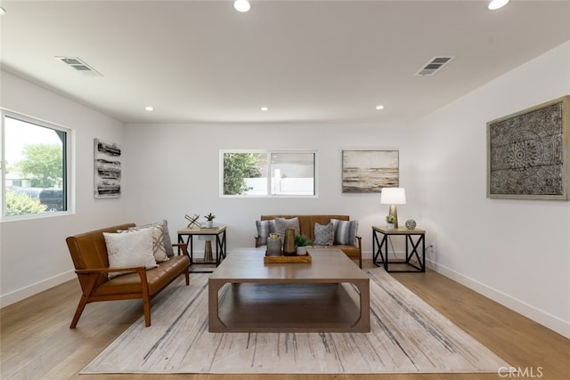 sitting room with baseboards, light wood-style flooring, visible vents, and recessed lighting