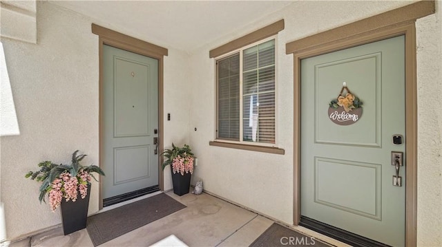 property entrance with stucco siding