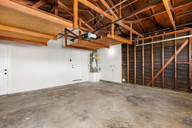 garage featuring water heater and a garage door opener