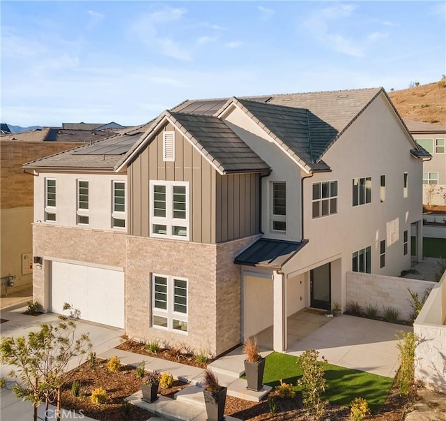 view of front of house with a garage and solar panels