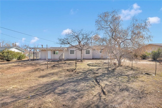 view of front of property with an attached carport and a front yard