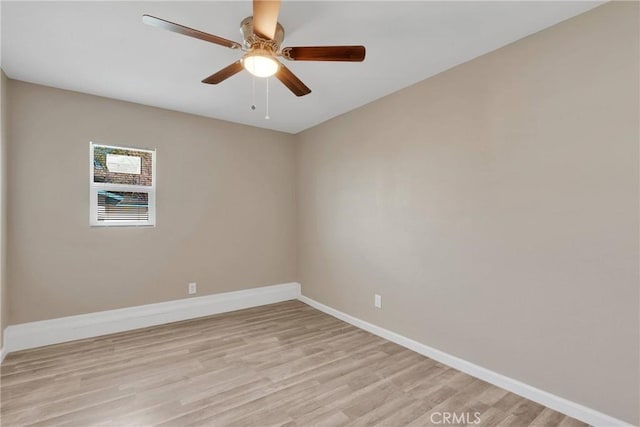 unfurnished room with ceiling fan, light wood-style floors, and baseboards