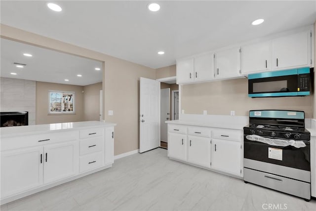 kitchen featuring recessed lighting, white cabinets, marble finish floor, light countertops, and gas range