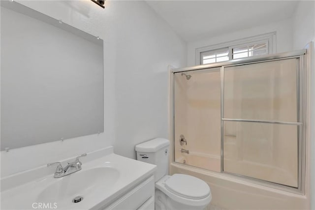 full bath with toilet, enclosed tub / shower combo, and vanity