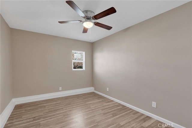 unfurnished room featuring ceiling fan, light wood-style flooring, and baseboards