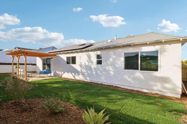 rear view of house featuring a pergola, a lawn, and a patio area