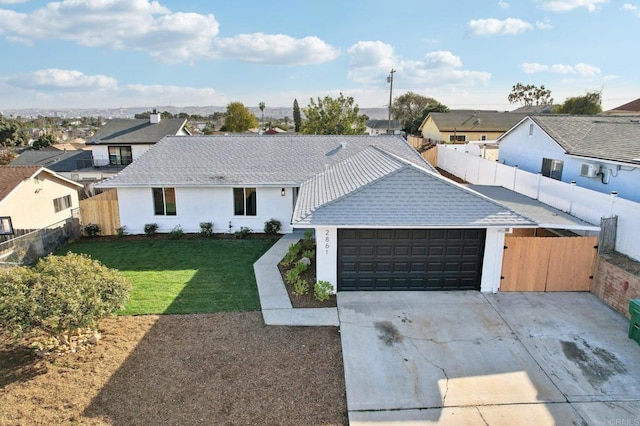 view of front of house featuring a front yard and a garage