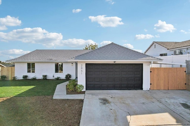 ranch-style home with a front lawn and a garage