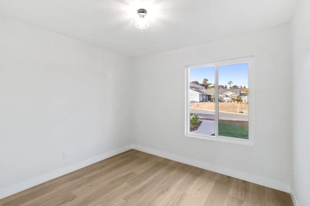 empty room with hardwood / wood-style flooring