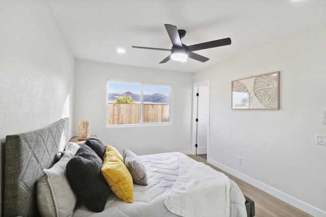 bedroom featuring ceiling fan and light hardwood / wood-style flooring