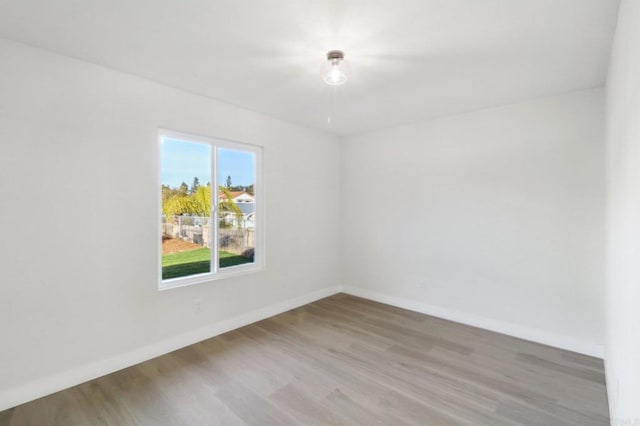 spare room featuring hardwood / wood-style flooring