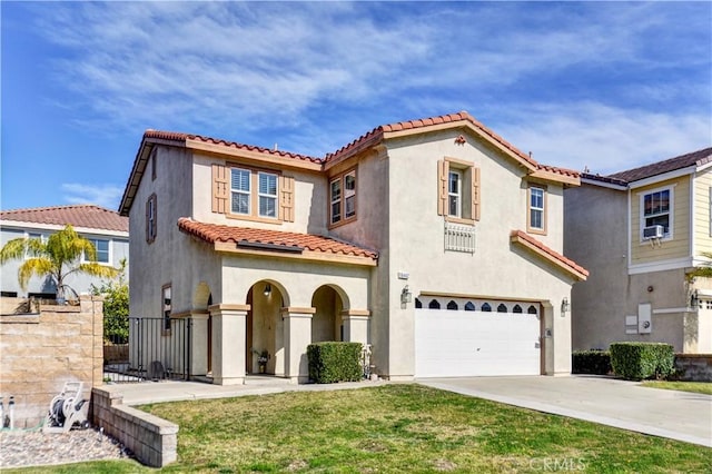 mediterranean / spanish-style home with a garage and a front lawn