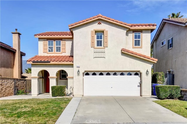 mediterranean / spanish-style house with a front yard and a garage