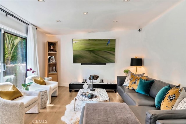 living room with recessed lighting and wood finished floors