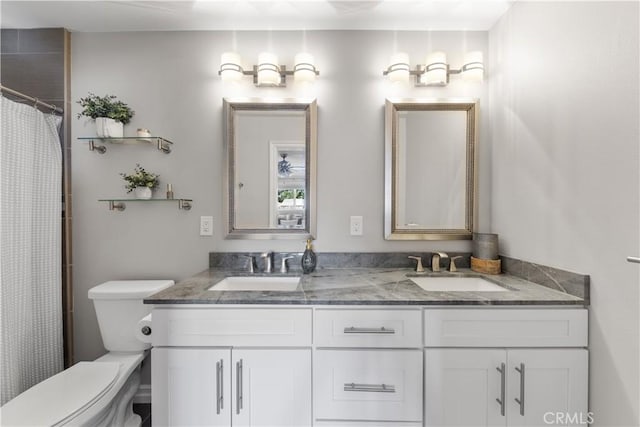 bathroom with toilet, vanity, and walk in shower