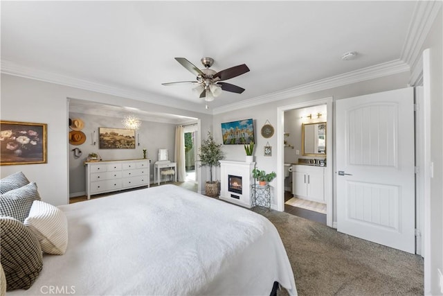 bedroom with carpet floors, ornamental molding, and ensuite bath