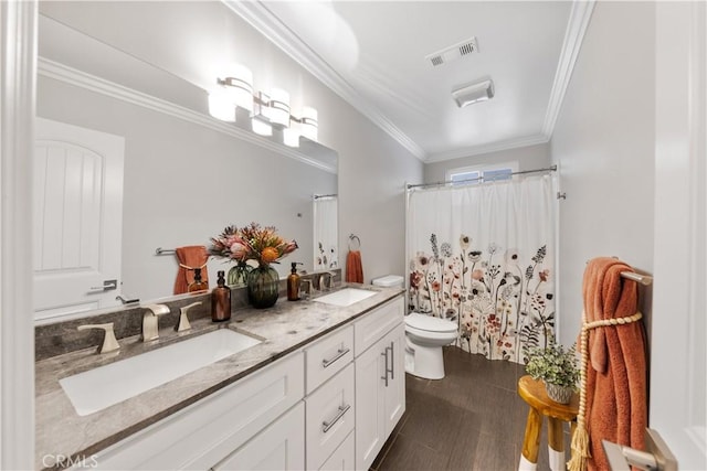 bathroom featuring ornamental molding, vanity, a shower with curtain, and toilet