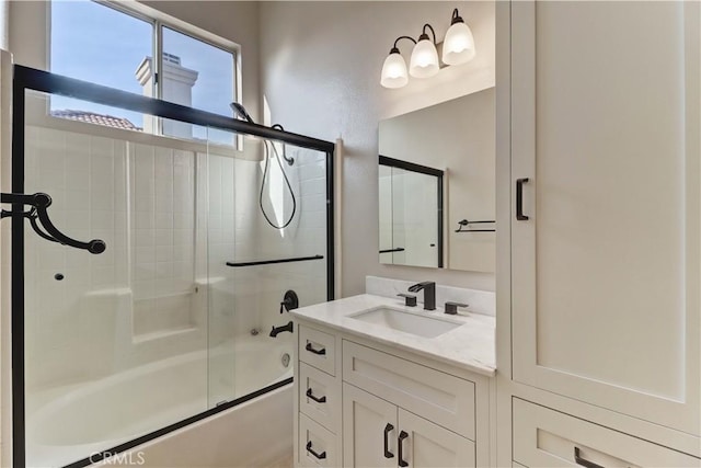 bathroom featuring vanity and bath / shower combo with glass door